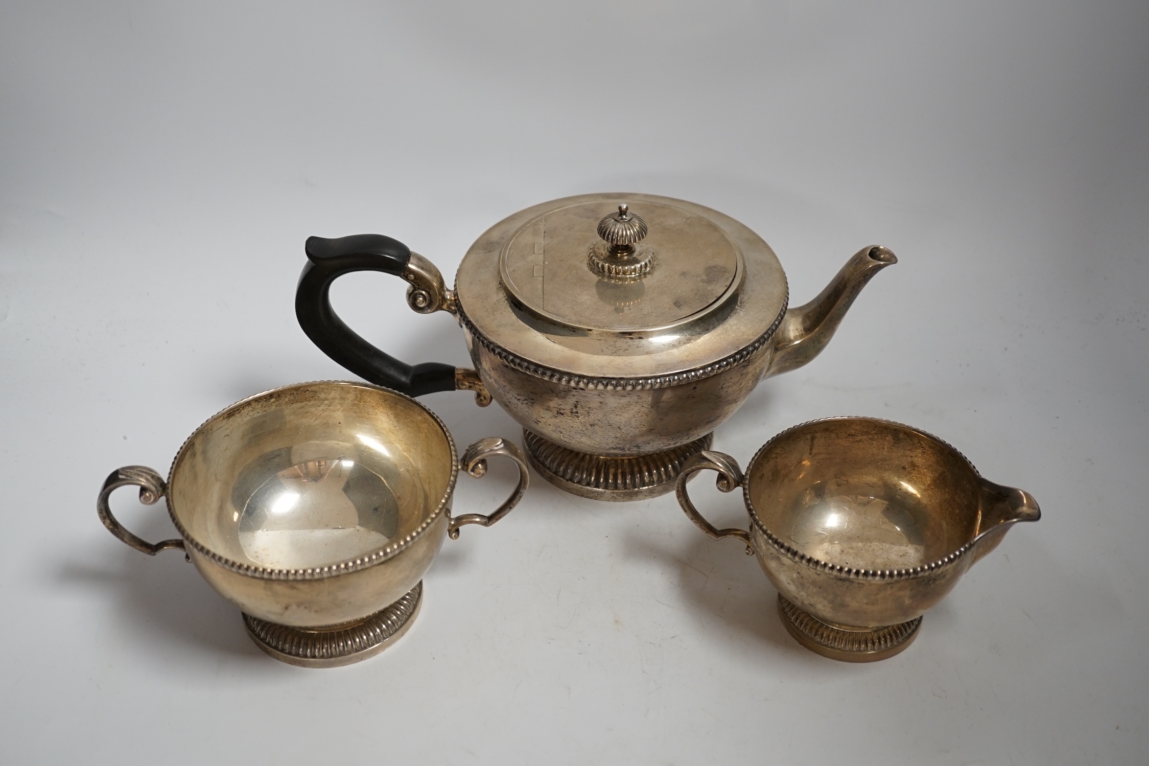 A George V three piece silver circular tea set, by James Dixon & Sons, Sheffield, 1935, gross weight 45,3oz